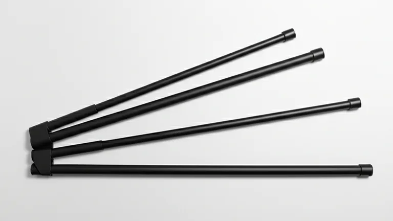 Overhead flat lay product photography of three matte black telescopic steel window security bars at different extension lengths on a white surface
